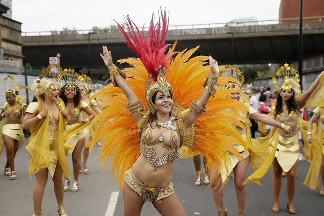 Costumed revellers perform in the parade during the Notting Hill Carnival in London, Monday, August 27, 2018. (Photo by Tim Ireland/AP Photo)