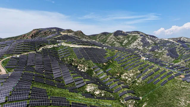 A photovoltaic power station is seen on a barren mountain in Zhangjiakou, Hebei province, China on August 9, 2023. (Photo by Costfoto/NurPhoto/Rex Features/Shutterstock)