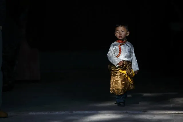 A Tibetan boy dressed in traditional attire arrives to take part in a function organised to mark Losar or the Tibetan New Year at Tibetan Refugee Camp in Lalitpur February 19, 2015. (Photo by Navesh Chitrakar/Reuters)