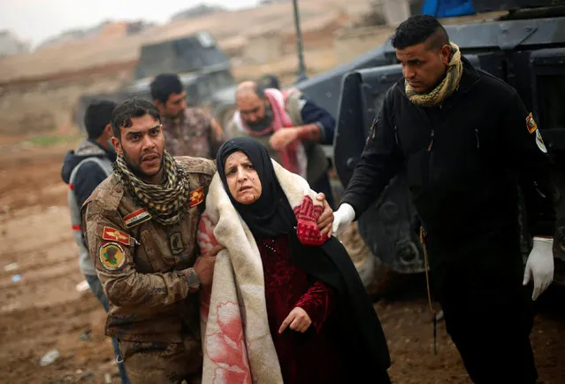An Iraqi woman, who was wounded during clashes in the Islamic State stronghold of Mosul, is brought into a field hospital in al-Samah neighborhood, Iraq December 1, 2016. (Photo by Mohammed Salem/Reuters)