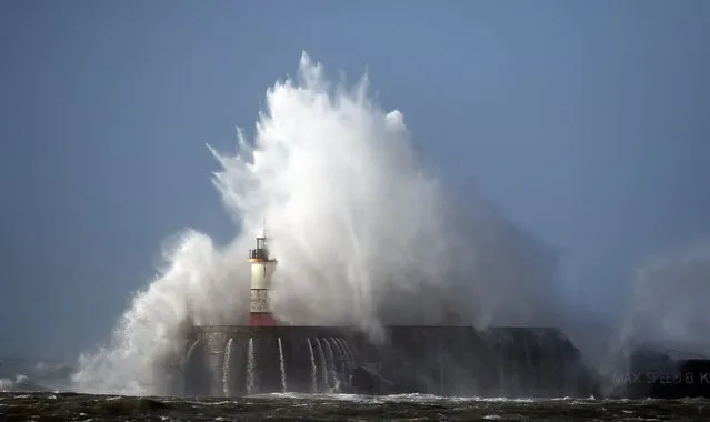 Waves crash over the harbour wall in Newhaven, southern England on March 11, 2021 as heavy gusts hit the south coast. (Photo by Glyn Kirk/AFP Photo)