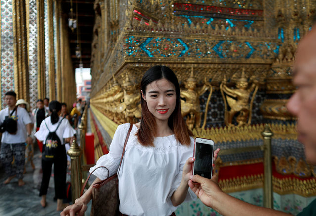 Chinese tourists visit the Temple of the Emerald Buddha in Bangkok, Thailand on August 19, 2018. (Photo by Soe Zeya Tun/Reuters)