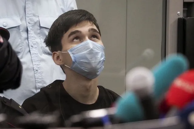 Ilnaz Galyaviyev, wearing a face mask to protect against coronavirus, sits during a hearing in a courtroom in Kazan, Russia, Wednesday, May 12, 2021. Russian officials say Galyaviyev attacked a school in the city of Kazan and Russian officials say several people have been killed. Russian media said the gunman was a former student at the school who called himself “a god” on his account on the messaging app Telegram and promised to “kill a large amount of biomass” on the morning of the shooting. Authorities also say over 20 others have been hospitalised with wounds. (Photo by Dmitri Lovetsky/AP Photo)