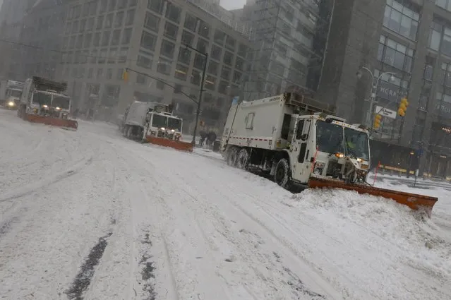 New York City Sanitation snow plows clear the streets around Columbus Circle during the first major winter storm in New York, New York, USA, 23 January 2016. The US East coast could receive more than 61 centimetres of snowfall before the storm is over, the College Park, Maryland-based weather centre said 23 January. (Photo by Peter Foley/EPA)