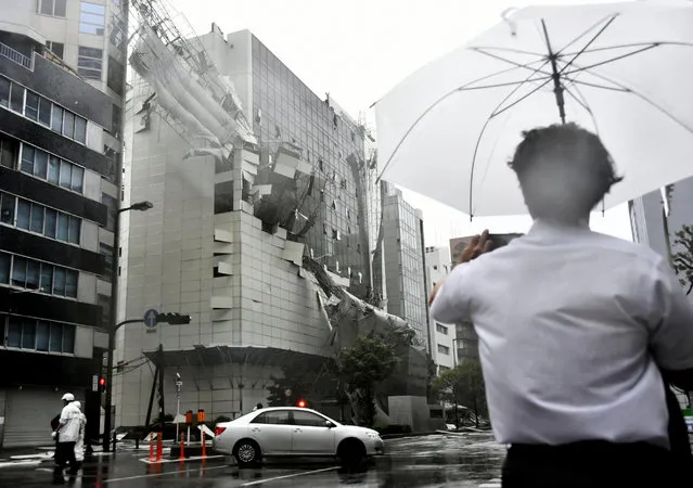 Scaffolding of a building being demolished, collapse, following a powerful typhoon in Osaka, western Japan, Tuesday, September 4, 2018. A powerful typhoon blew through western Japan on Tuesday, causing heavy rain to flood the region's main offshore international airport and high winds to blow a tanker into a connecting bridge, disrupting land and air travel. (Photo by Nobuki Ito/Kyodo News via AP Photo)