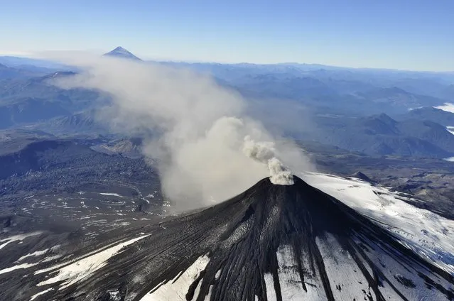 An aerial view shows smoke and ash rising from Villarrica Volcano, south of Santiago March 18, 2015. Villarrica Volcano which erupted earlier this month before settling down, has entered a more active phase again, expelling gas and ash into the atmosphere, Chilean authorities said on Wednesday. (Photo by Reuters/Stringer)