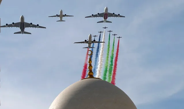 Al Fursan aerobatic display team with four UAE airline carriers Emirates, Etihad, flydubai and Air Arabia perform by flying over Sheikh Zayed Mosque, as a performance to celebrate the UAE's 47th National Day and the Year of Zayed, in Abu Dhabi in addition to other places from UAE, United Arab Emirates, 02 December 2018. UAE citizens and residents celebrate National Day on 02 December marking the unification of the seven emirates, Abu Dhabi, Dubai, Sharjah, Fujairah, Ras al-Khaimah, Ajman and Umm al-Quwain into the United Arab Emirates, and freedom from the British Protectorate. (Photo by Ali Haider/EPA/EFE)