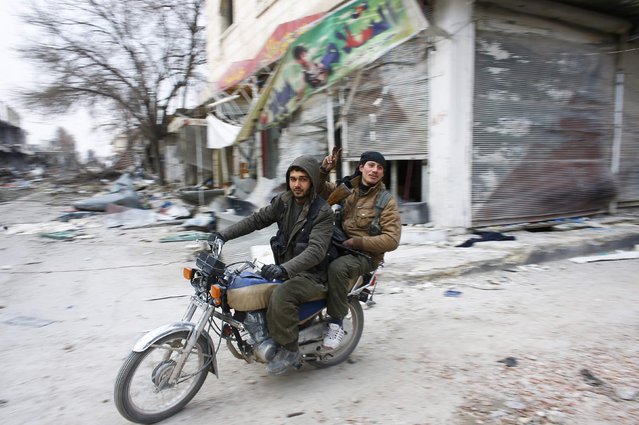 Fighters of the Kurdish People's Protection Units (YPG) patrol on a motorcycle in the streets of the northern Syrian town of Kobani January 28, 2015. (Photo by Osman Orsal/Reuters)