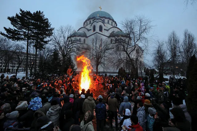 Believers burn dried oak branches, which symbolises the Yule log, on Orthodox Christmas Eve in front of the St. Sava temple in Belgrade, Serbia, January 6, 2017. (Photo by Marko Djurica/Reuters)