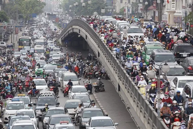 Vehicles are seen along a street in Hanoi March 30, 2015. Famous for its swarms of scooters, Vietnam is seeing auto sales surge amid the rapid expansion of a young, style-conscious middle class after 15 straight years of economic growth of over 5 percent. (Photo by Reuters/Kham)