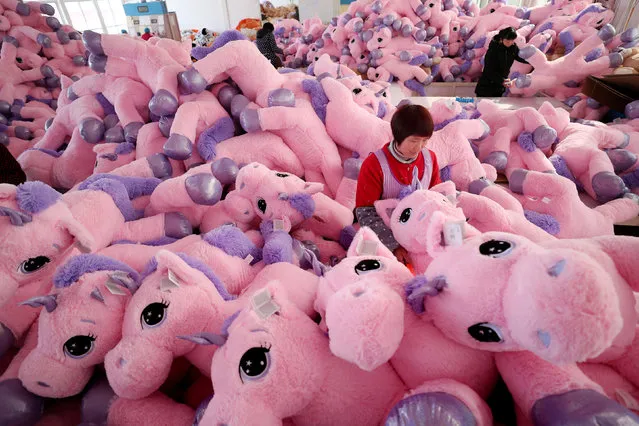 Women work on unicorn stuffed toys for export at a workshop in Lianyungang, Jiangsu province, China February 21, 2019. (Photo by Reuters/China Stringer Network)