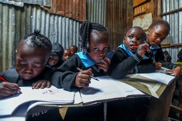 Students learn how to write in a class of a makeshift school as more than half of the people the country try to survive in shacks due to financial reasons such as inadequate schools, lack of infrastructure and insufficient school supplies in Kibera neighborhood of Nairobi, Kenya on January 10, 2024. (Photo by Gerald Anderson/Anadolu via Getty Images)