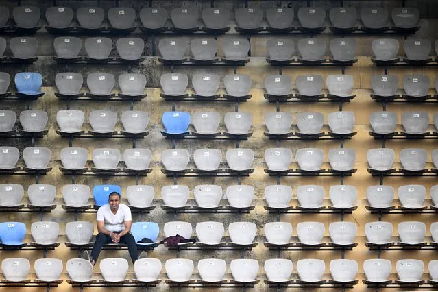 A spectator watches from the stands the first day of the second Test cricket match between India and England at the Y.S. Rajasekhara Reddy cricket stadium in Visakhapatnam on February 2, 2024. (Photo by Dibyangshu Sarkar/AFP Photo)