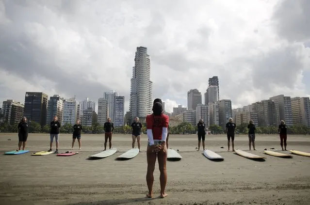 Teacher Denise (C), 55, gives a surfing lesson to elderly people during their surf class in Santos, Sao Paulo state, Brazil March 17, 2016. (Photo by Nacho Doce/Reuters)