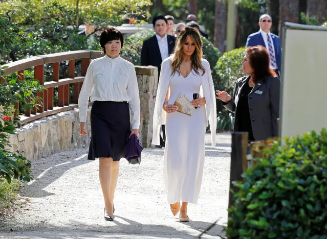U.S. First Lady Melania Trump (C) and Akie Abe (L), wife of Japanese Prime Minister Shinzo Abe, listen to Park Administrator Bonnie White Lemay, as they tour Morikami Museum and Japanese Gardens in Delray Beach, Florida, U.S., February 11, 2017. (Photo by Joe Skipper/Reuters)