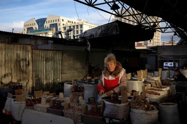 A woman sells produce at Pryvoz Market, amid Russia's attack on Ukraine, in Odesa, Ukraine on February 8, 2024. (Photo by Thomas Peter/Reuters)