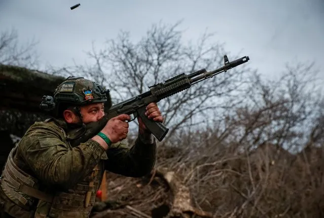 A Ukrainian serviceman from an air defence unit of the 93rd Mechanized Brigade fires a AK-74 assault rifle at a frontline, near the town of Bakhmut, Ukraine, on March 6, 2024. (Photo by Serhii Nuzhnenko/Radio Free Europe/Radio Liberty)