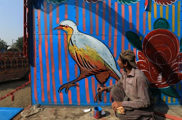 Hazrat Hussain, 19, a truck art painter, makes a painting of a bird to decorate a truck at a workshop in Peshawar, Pakistan on November 20, 2023. (Photo by Fayaz Aziz/Reuters)