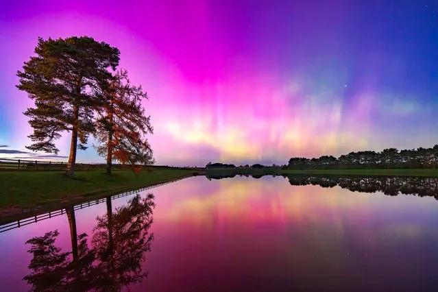 The Northern Lights (Aurora Borealis) seen over Whittle Dene reservoir in Northumberland with reflections in the water. (Photo by Alamy Stock Photo)