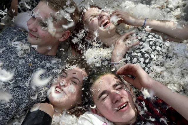People react as they take part in a pillow fight during a flash mob in Kiev, Ukraine, April 24, 2016. (Photo by Valentyn Ogirenko/Reuters)