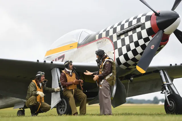 Re-enactors from Angels on our Wings, a Second World War re-enactment group, stand by TF-51D Mustang “Contrary Mary” during the Flying Legends Air Show at IWM Duxford, England on July 14, 2019. (Photo by Joe Giddens/PA Images via Getty Images)