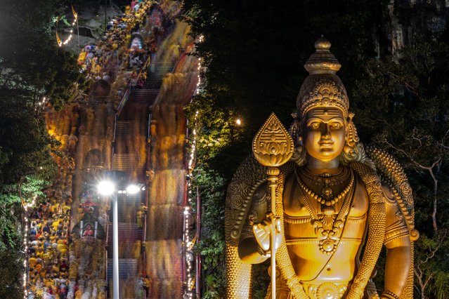 This image taken with a slow shutter speed shows Hindu devotees climbs the 272 stairs to towards the Batu Caves temple to make offerings during the Thaipusam festival at Batu Caves on the outskirts of Kuala Lumpur on January 25, 2024. Hundreds of thousands of Hindus celebrated the annual Thaipusam festival on January 24, gathering in temples across Malaysia, with many displaying their devotion by piercing their bodies with hooks and skewers. (Photo by Mohd Rasfan/AFP Photo)