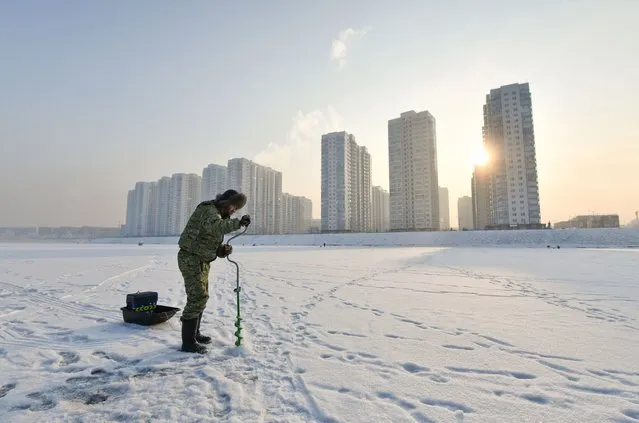 Vyacheslav is 25 years old spends weekend at ice fishing in one of the chanels of Yenisey river in Krasnoyarsk, Russia on January 22, 2022. Vyacheslav tells many siberians like fishing. He has some special equipment for ice fishing. He use an underwater camera to check out the place for fishing. (Photo by Alexander Manzyuk/Anadolu Agency via Getty Images)