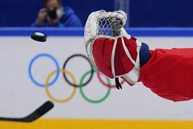 Canada goalkeeper Eddie Pasquale reaches for a shot against United States during a preliminary round men's hockey game at the 2022 Winter Olympics, Saturday, February 12, 2022, in Beijing. (Photo by Matt Slocum/AP Photo)