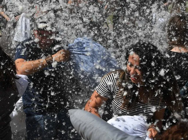 Feathers fly as participants attack each other with pillows during an International Pillow Fight Day event at Pershing Square in Los Angeles, California on April 1, 2017. (Photo by Mark Ralston/AFP Photo)