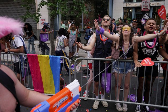 A person sprays attendees with a water gun while taking part in the annual LGBTQ+ Capital Pride parade in Washington on June 8, 2024. (Photo by Nathan Howard/Reuters)