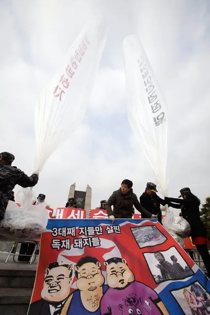 North Korean defectors, now living in South Korea, prepare to release balloons carrying propaganda leaflets denouncing North Korea's late leader Kim Jong-Il at Imjingak, near the Demilitarized zone