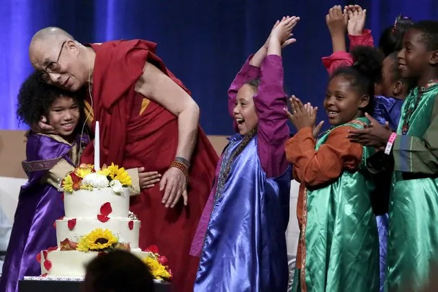 A group of children celebrate with the Dalai Lama after he blew out a candle on his birthday cake at the University of California, Irvine July 6, 2015. (Photo by Jonathan Alcorn/Reuters)