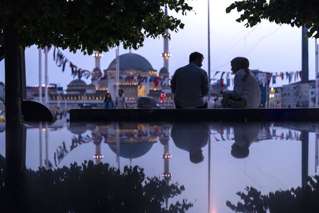 A couple sit in a public bench at Taksim square in Istanbul, Turkey, Wednesday, May 22, 2024. (Photo by Francisco Seco/AP Photo)