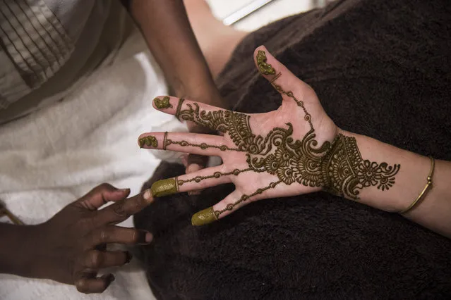 Reporter Andrea Sachs has Henna or Mehndi, a traditional paste that leaves a temporary tattoo typically for special occasions such as a wedding, applied to her hand at the Trident Hotel in Mumbai, India on Monday May 09, 2016. (Photo by Jabin Botsford/The Washington Post)