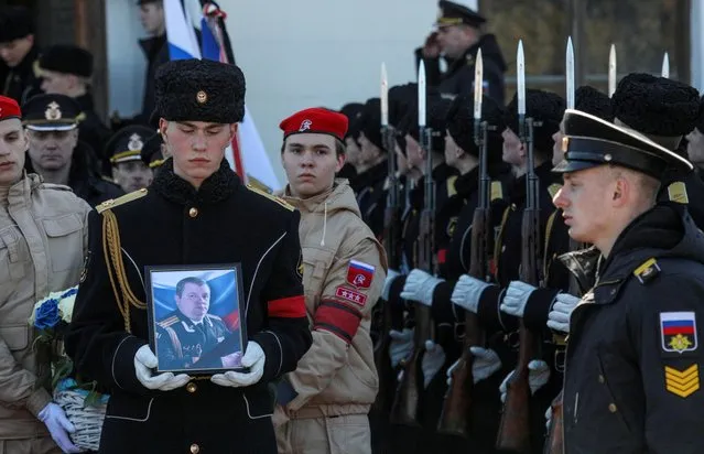 Sailors attend a memorial and funeral service for first rank captain Andrei Paliy, Russia's Black Sea Fleet deputy commander, who was killed in the eastern Ukrainian port city of Mariupol on March 20, in Sevastopol, Crimea on March 23, 2022. (Photo by Alexey Pavlishak/Reuters)