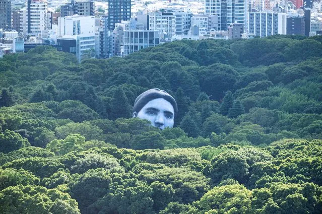 A hot air balloon created by Japanese art group “mé” floats over Tokyo’s Yoyogi Park on July 16, 2021, part of a project called “Masayume” – a Japanese word for a dream that becomes reality. (Photo by Charly Triballeau/AFP Photo)