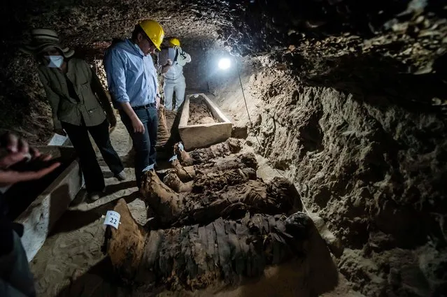 Egyptian Antiquities Minister Khaled el- Enany (C) speaks to the media on May 13, 2017, in front of mummies following their discovery in catacombs in the Touna el- Gabal district of the Minya province, in central Egypt. The necropolis, which is eight metres below ground level, dates back to the Late Period of Ancient Egypt and the Greco-Roman period. (Photo by Khaled Desouki/AFP Photo)