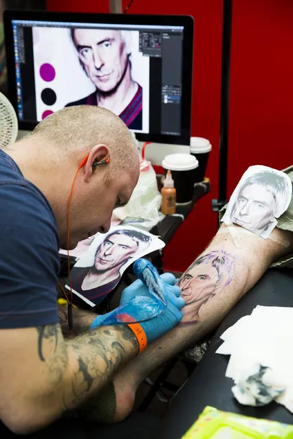 A man gets tattooed at The Great British Tattoo Show at Alexandra Palace on May 24, 2014 in London, England. (Photo by Tristan Fewings/Getty Images for Alexandra Palace)