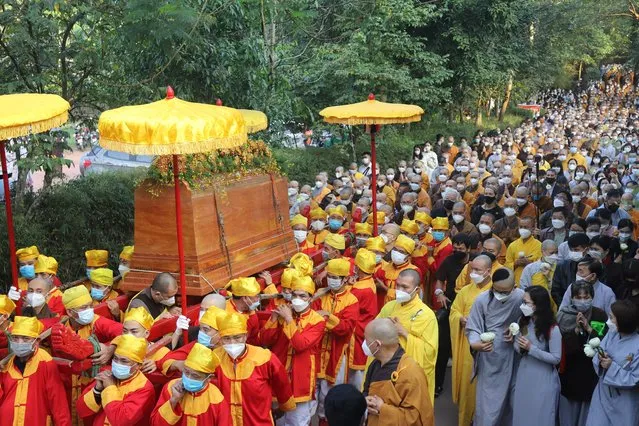 Coffin of Vietnamese Buddhist monk Thich Nhat Hanh is carried to the street during his funeral in Hue, Vietnam Saturday, January 29, 2022. A funeral was held Saturday for Thich Nhat Hanh, a week after the renowned Zen master died at the age of 95 in Hue in central Vietnam. (Photo by Thanh Vo/AP Photo)