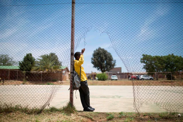 A student from the Soweto Rugby School Academy can be seen resting before practice in Soweto, South Africa, on November 6, 2019. These players are part of the Soweto Rugby School Academy (SRSA), one of the three rugby schools of Soweto, a black township of Johannesburg housing more than 1.3 million people. Founded in 2016 the SRSA welcome some 250 students of age between 8 and 19, of which almost 50 are girls. (Photo by Guillem Sartorio/AFP Photo)