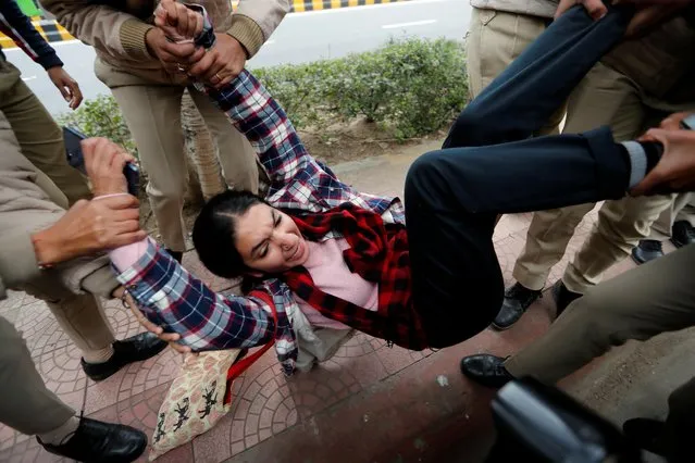 Police detain a woman demonstrating after deadly clashes with police in Uttar Pradesh, following days of violent protests across India against a new citizenship law, in front of Uttar Pradesh state bhawan (building) in New Delhi, India, December 23, 2019. (Photo by Adnan Abidi/Reuters)