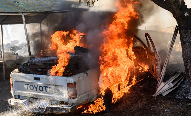 A truck burns outside a residence as the Boyles Fire burns in Clearlake, California, on September 8, 2024. The fire has thus far burned at least 30 homes and is being investigated for arson. (Photo by Josh Edelson/AFP Photo)