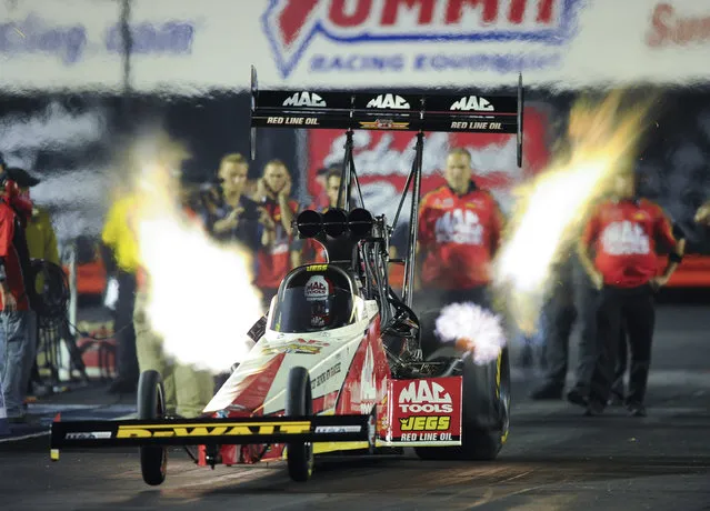 In this photo provided by NHRA, Doug Kalitta drives in Top Fuel qualifying Friday, June 23, 2017, at the Summit Racing Equipment NHRA Nationals in Norwalk, Ohio. Kalitta leads the Top Fuel category after the first day of qualifying. (Photo by Teresa Long/NHRA via AP Photo)