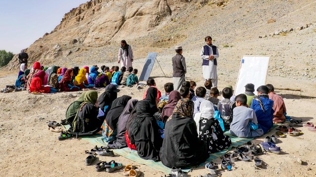 Afghan children attend an open-air school in Firozkoh, Ghor province on August 31, 2024. (Photo by Mohsen Karimi/AFP Photo)