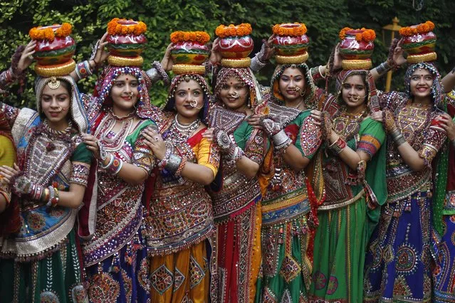 Indian women in traditional attire pose for photographs before practicing Garba, a traditional dance of Gujarat state, ahead of Hindu festival of Navratri in Ahmadabad, India, Friday, October 1, 2021. The Hindu festival of Navratri or nine nights will begin from Oct. 7. (Photo by Ajit Solanki/AP Photo)