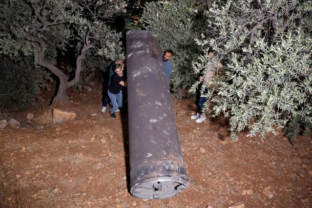 Palestinians investigate a projectile, after Iran fired a salvo of ballistic missiles, in Tubas, in the Israeli-occupied West Bank, on October 1, 2024. (Photo by Raneen Sawafta/Reuters)