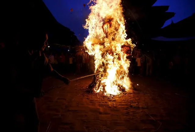 People set fire to an effigy of the demon Ghantakarna, during the Ghantakarna festival at the ancient city of Bhaktapur, Nepal August 12, 2015. (Photo by Navesh Chitrakar/Reuters)
