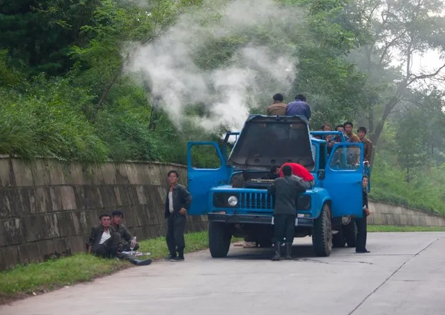 The kind of scene you can see along the highway. Overloaded trucks but broken down with lot of smoke coming out... I was allowed to make those pics as after lunch, my guides were enjoying the confort of the bus seats and snoring... (Photo by Eric Lafforgue/Exclusivepix Media)