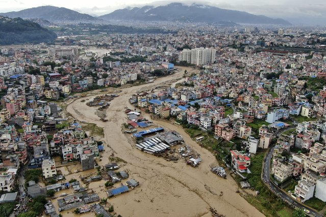 In this aerial image of the Kathmandu valley, Bagmati River is seen flooded due to heavy rains in Kathmandu, Nepal, Saturday, September 28, 2024. (Photo by Gopen Rai/AP Photo)