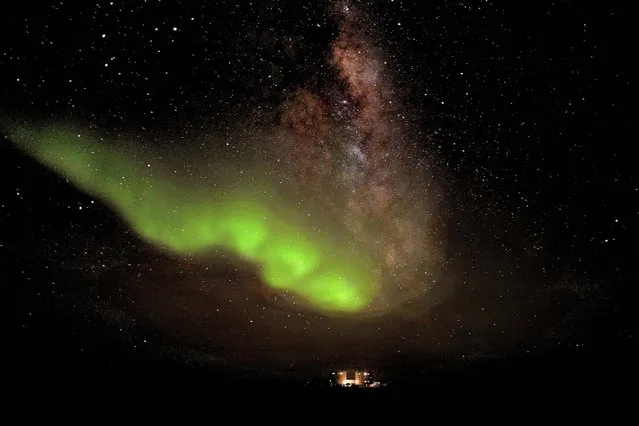 This image released by the European Space Agency shows the Aurora Australis, or the southern lights, glowing over Concordia station in the Antarctic, one of the remotest places on Earth, on July 18, 2012. It was taken by ESA-sponsored scientist Alexander Kumar and his colleague Erick Bondoux from about 6 miles from the station, located in the Antarctic at 75 S latitude. (Photo by European Space Agency)